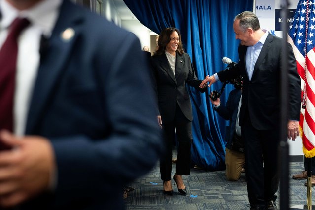 Second Gentleman Douglas Emhoff greets his wife US Vice President and Democratic presidential candidate Kamala Harris as she walks out to speak to campaign staff at her Presidential Campaign headquarters in Wilmington, Delaware on July 22, 2024. Harris on January 22, won the crucial backing of Democratic heavyweight Nancy Pelosi to lead the party against Donald Trump in November after Joe Biden's stunning exit from the 2024 race. As the endorsements stacked up, the 59-year-old Harris made her first public appearance since Biden's announcement in a ceremony at the White House where she warmly praised the outgoing president's “unmatched” achievements. (Photo by Erin Schaff/AFP Photo)