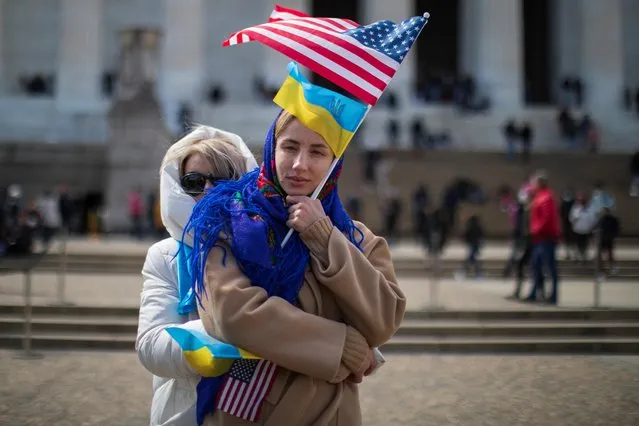 Anna embraces Iryna while listening to a pre-recorded video of Ukraine President Volodymyr Zelenskyy, during a “Stand with Ukraine” rally at the Lincoln Memorial on the National Mall in Washington, U.S., March 27, 2022. (Photo by Tom Brenner/Reuters)