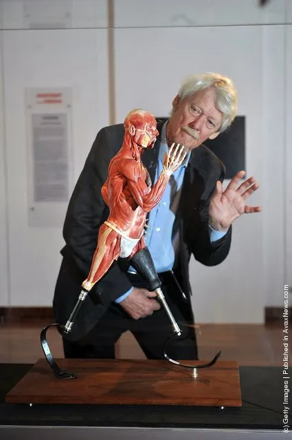 Artist Richard Neave admires the sculpture 'Sprinting' that he created with Denise Smith in London