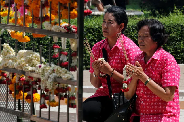 Well-wishers wear pink shirts as they pray for Thailand's King Bhumibol Adulyadej at Siriraj Hospital in Bangkok, Thailand, October 11, 2016. (Photo by Chaiwat Subprasom/Reuters)