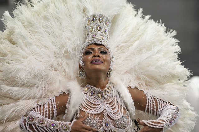 A dancer from the Academicos do Tucuruvi samba school performs during a carnival parade in Sao Paulo, Brazil, Friday, April 22, 2022. (Photo by Andre Penner/AP Photo)