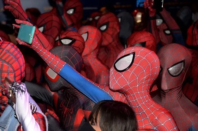 Fans dressed in Spider-Man outfits gather at a promotional event for the forthcoming “Spider-Man: Homecoming” movie at the Art Science Museum in Singapore on June 7, 2017. The movie will be shown in cinemas around the world from July 5 onwards. (Photo by Toh Ting Wei/AFP Photo)