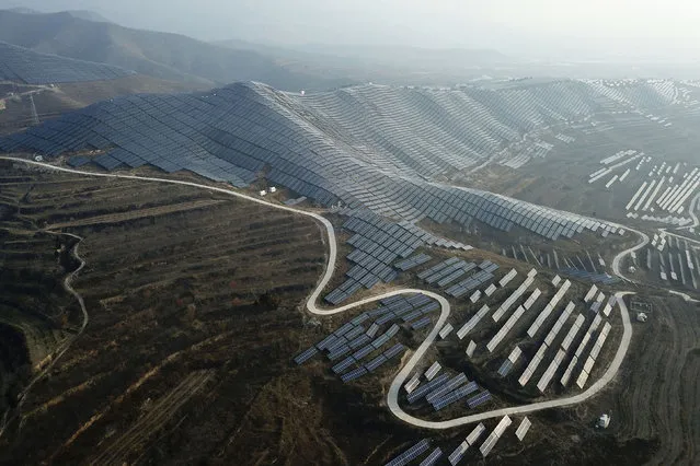 In this November 28, 2019, photo, a solar panel installation is seen in Ruicheng County in central China's Shanxi Province. As world leaders gather in Madrid to discuss how to slow the warming of the planet, a spotlight is falling on China, the top emitter of greenhouse gases. China burns about half the coal used globally each year. Yet it's also the leading market for solar panels, wind turbines and electric vehicles. (Photo by Sam McNeil/AP Photo)
