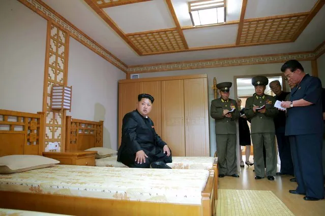 North Korean leader Kim Jong Un (L) gives guidance during his visit to the newly-built Pyongyang Home for the Aged in this undated photo released by North Korea's Korean Central News Agency (KCNA) on August 2, 2015. (Photo by Reuters/KCNA)