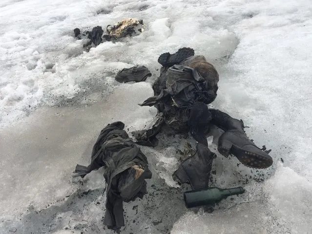 A handout photo made available by Glacier 3000, showing the weathered garments, hiking boots and other items found alongside the bodies of two people believed to be Marcelin and Francine Dumoulin, on the Tsanfleuron glacier in the area of the Glacier 3000 above Les Diablerets VD on 13 July 2017 (issued 18 July 2017). The couple disappeared after going to tend to their cows in the Alps in 1942. The bodies are clad in clothing dating from around World War Two and are believed to have been buried in ice for 70 to 80 years. A DNA test has yet to be carried out on the bones. Bodies of couple found after being buried in ice for decades, Les Diableret, Switzerland. (Photo by EPA/Rex Features/Shutterstock)