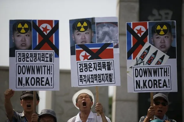 Men from an anti-North Korea and conservative civic group chant slogans during an anti-North Korean rally near the demilitarized zone separating the two Koreas in Paju, South Korea, August 11, 2015. South Korea's military on Monday threatened retaliation against North Korea after accusing the North of planting land mines inside the Demilitarised Zone border that wounded two soldiers last week, in what it called a cowardly act of provocation. (Photo by Kim Hong-Ji/Reuters)