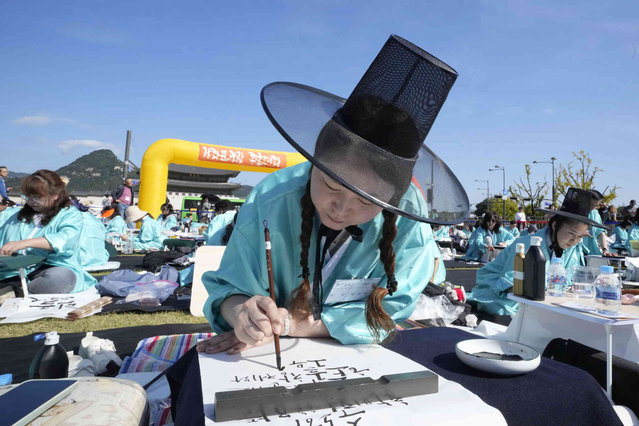 South Korean woman Park Soo-mi takes part in a Korean calligraphy contest as part of events to celebrate the 578th anniversary of the creation of the Korean alphabet, Hangeul, in Seoul, South Korea, Wednesday, October 9, 2024. (Photo by Ahn Young-joon/AP Photo)