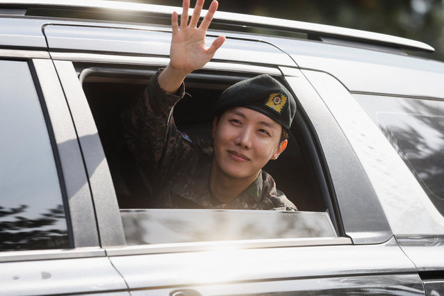 K-pop boy band BTS member J-Hope waves from inside a vehicle after being discharged from his 18 months of mandatory military service outside a military base in Wonju, South Korea on October 17, 2024. (Photo by Kim Soo-hyeon/Reuters)