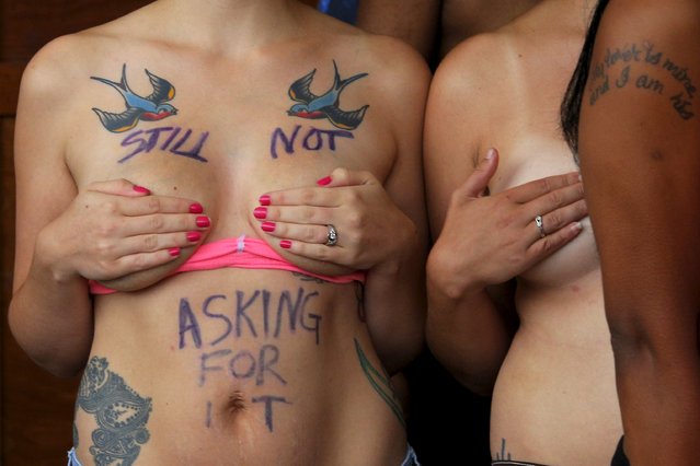 Topless activist Brianna Locke, with the words “Still Not Asking for It” written on her chest, poses for a television news report during a “Free the Nipple” demonstration in Hampton Beach, New Hampshire August 23, 2015. Hundreds of bare-breasted women are expected to converge on a popular New Hampshire beach on Sunday to push for greater acceptance of topless sunbathing, much to the consternation of some local residents and officials. (Photo by Brian Snyder/Reuters)