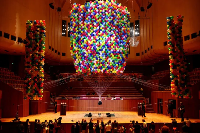 Austrian British artist Nomi Lakmaier is bound,immobilised and lifted by 20,000 multi-coloured party balloons during a nine hour performance on the stage of the Concert Hall at the Sydney Opera House on September 3, 2017 in Sydney, Australia. The artwork titled 'Cherophobia' explores notions of desire, restraint and control. It has been staged only once before in London as part of the Unlimited Festival. (Photo by Cameron Spencer/Getty Images)