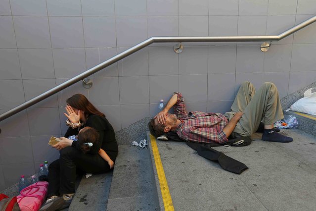 Migrants rest on the steps to an underground station near the main Eastern Railway station in Budapest, Hungary, September 1, 2015. (Photo by Laszlo Balogh/Reuters)