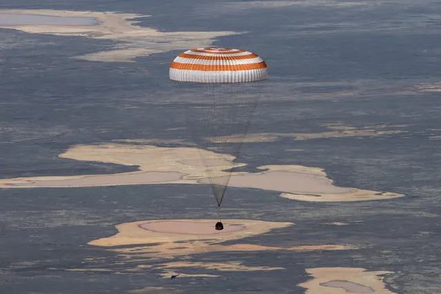 In this handout photo released by Gagarin Cosmonaut Training Centre (GCTC), Roscosmos space agency, the Soyuz MS-15 space capsule carrying International Space Station (ISS) crew members descends beneath a parachute just before landing in a remote area near Kazakh town of Dzhezkazgan, Kazakhstan, Friday, April 17, 2020. An International Space Station crew has landed safely after more than 200 days in space. The Soyuz capsule carrying NASA astronauts Andrew Morgan, Jessica Meir and Russian space agency Roscosmos' Oleg Skripochka touched down on Friday on the steppes of Kazakhstan. (Photo by Andrey Shelepin, Gagarin Cosmonaut Training Centre (GCTC), Roscosmos space agency, via AP Photo)