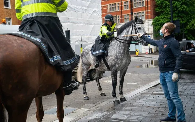 Police horses arrive at a free drive-through for the emergency services at The Berkeley Hotel in London on April 28, 2020, as the UK continues in lockdown to help curb the spread of the coronavirus. (Photo by Aaron Chown/PA Images via Getty Images)