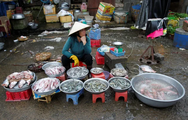 A woman displays seafood for sale at a market in Vietnam's central highland city of Bao Loc December 13, 2011. (Photo by Reuters/Kham)