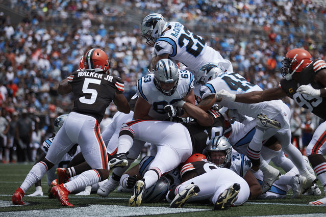 Carolina Panthers running back Christian McCaffrey (22) leaps over the pile to score a touchdown during an NFL football game against the Cleveland Browns, Sunday, September 11, 2022, in Charlotte, N.C. (Photo by Brian Westerholt/AP Photo)