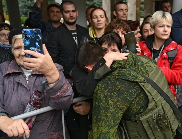 A woman says goodbye to a reservist drafted during partial mobilisation, before his departure for a military base, in the city of Bataysk, in the Rostov region, Russia on September 26, 2022. (Photo by Sergey Pivovarov/Reuters)
