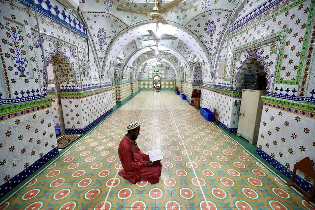 A Muslim devotee recites the Koran at the Star Mosque during Ramadan in Dhaka, Bangladesh, April 26, 2020. (Photo by Mohammad Ponir Hossain/Reuters)