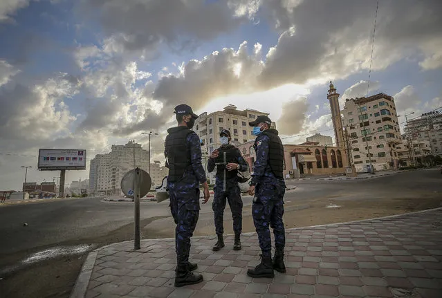 Palestinian policemen wearing face masks patrol to prevent people from gathering in front of the sea of Gaza, in Gaza City, Gaza Strip, 24 May 2020. Gaza is under a nationwide lockdown due to the ongoing pandemic of the COVID-19 disease caused by the SARS-CoV-2 coronavirus. (Photo by Mohammed Saber/EPA/EFE/Rex Features/Shutterstock)