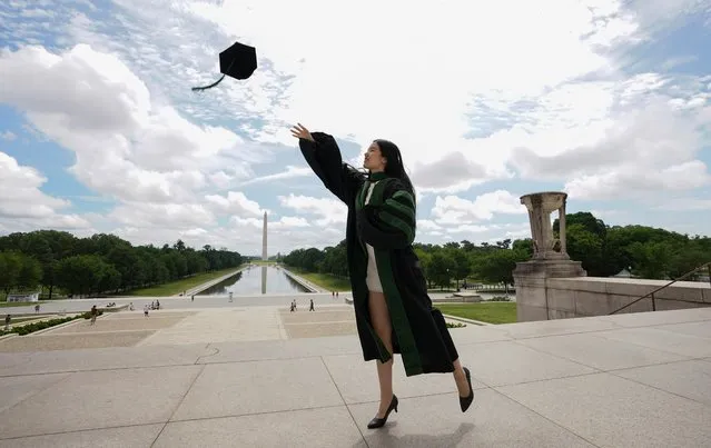 As the national death toll from the coronavirus disease (COVID-19) nears 100,000, Georgetown University medical school graduate He Zhou casts her cap into the air at the Lincoln Memorial in Washington, U.S., May 27, 2020. (Photo by Kevin Lamarque/Reuters)