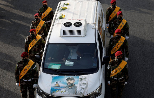 A vehicle carries the coffin of a commander from Iraq's Kataib Hezbollah armed group who was killed in what they called a “Zionist attack” in the Syrian capital Damascus on Friday, during a funeral in Baghdad, Iraq on September 22, 2024. (Photo by Thaier Al-Sudani/Reuters)