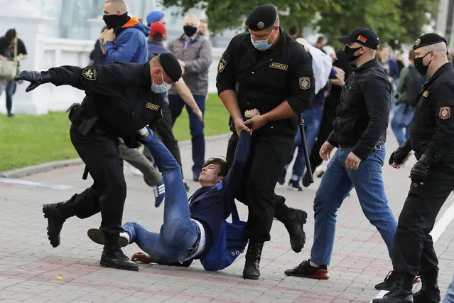 Police officers detain a protester during a rally against the removal of opposition candidates from the presidential elections in Minsk, Belarus, Tuesday July 14, 2020. Election authorities in Belarus on Tuesday barred two main rivals of authoritarian leader Alexander Lukashenko from running in this summer's presidential election. (Photo by Sergei Grits/AP Photo)