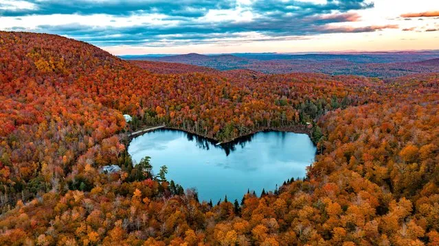 In this aerial image, Baker Lake is surrounded by Fall colors on October 8, 2022 near East Bolton, Quebec, Canada. (Photo by Sébastien St-Jean/AFP Photo)