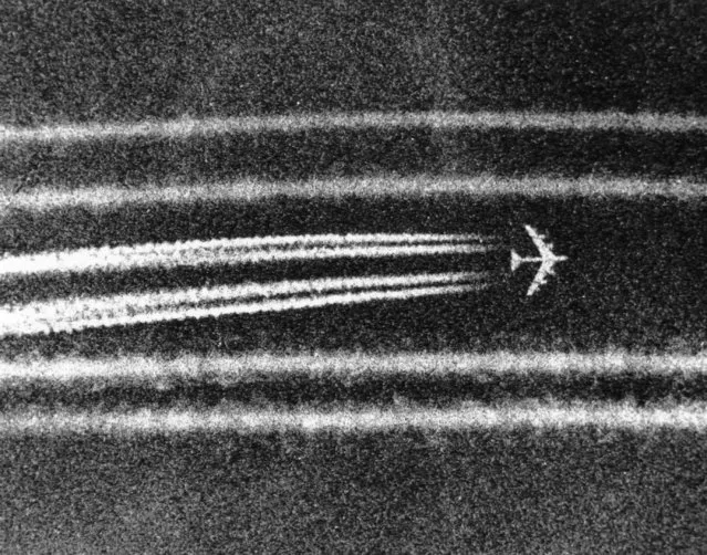 B52 high altitude bombers leave miles-long condensation trails while passing the town of Cai Lay in the Mekong Delta on September 29, 1972, moments after unleashing tons of bombs on suspected enemy positions. The giant jet aircraft are virtually invisible at altitude save for the "contrails". (Photo by Nick Ut/AP Photo)