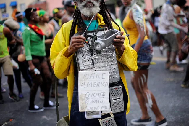 A man wears a sign making fun of U.S. Republican presidential nominee Donald Trump's slogan during J'Ouvert, ahead of the annual West Indian-American Carnival Day Parade in Brooklyn, NY, U.S. September 5, 2016. (Photo by Mark Kauzlarich/Reuters)