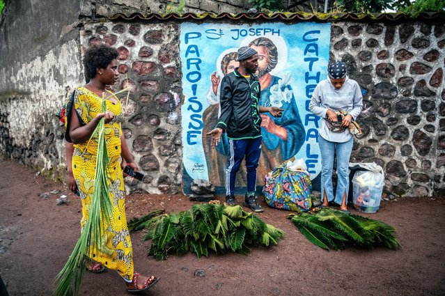 Catholic faithful buy palm branches outside Goma Cathedral ahead of the Palm Sunday mass, locally known as Matawi, in Goma, Democratic Republic of the Congo on April 13, 2025. (Photo by Jospin Mwisha/AFP Photo)
