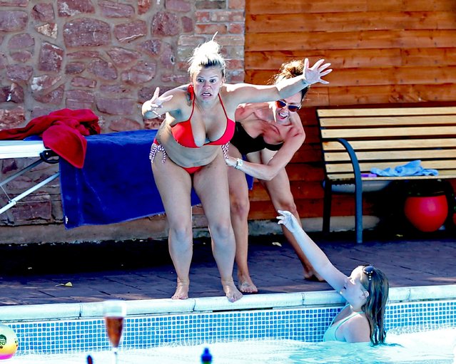 British reality stars Kerry Katona and Michelle Heaton Relax poolside with their families in Bridgwater, Somerset, England on August 30, 2016. Kerry Katona was wearing a “Swag” t-shirt before stripping down to a red bikini. Kerry looked to be having a great time with Michelle and family. (Photo by FameFlynet UK)