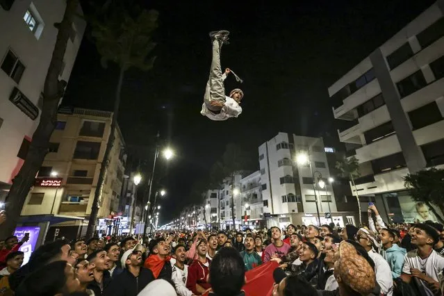 Morocco's supporters celebrate after their country's win of the Qatar 2022 World Cup football match between Morocco and Portugal, in the capital Rabat, on December 10, 2022. (Photo by Fadel Senna/AFP Photo)