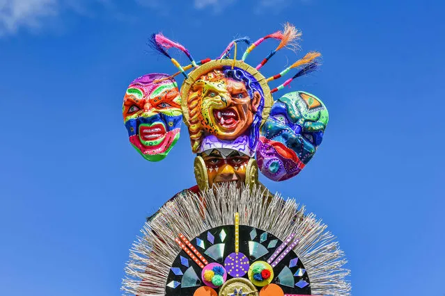 A reveller takes part in the “Canto a la Tierra” parade on January 3, 2018, during the Carnival of Blacks and Whites in Pasto, Colombia, the largest festivity in the south- western region of the country. (Photo by Luis Robayo/AFP Photo)