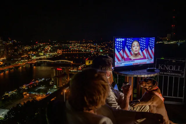 Guests watch television coverage of the Democratic National Convention at a virtual DNC party overlooking the city on August 18, 2020 in Pittsburgh, Pennsylvania. (Photo by Jeff Swensen/Getty Images)
