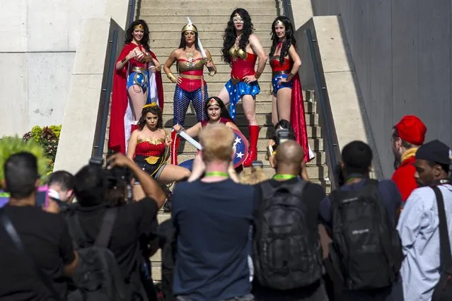 A group of people dressed as Wonder Woman pose for photographers on day two of New York Comic Con in Manhattan, New York, October 9, 2015. (Photo by Andrew Kelly/Reuters)