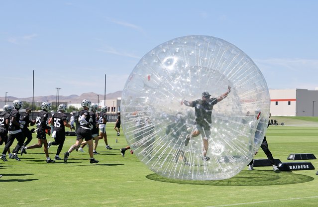 Las Vegas Raiders defensive players run by an inflatable ball with equipment specialist John Miranda inside during mandatory minicamp at the Las Vegas Raiders Headquarters/Intermountain Healthcare Performance Center on June 12, 2025 in Henderson, Nevada. (Photo by Ethan Miller/Getty Images)
