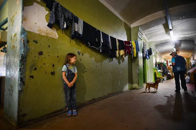 A girl stands in a communal corridor in a dormitory for the workers of Proletarka textile factory in the town of Tver, 200 kilometres north-west from Moscow on August 8, 2020. (Photo by Andrey Borodulin/AFP Photo)