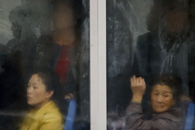 Commuters are seen inside a bus in central Pyongyang, October 11, 2015. (Photo by Damir Sagolj/Reuters)