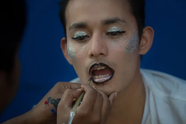 This photo taken on January 28, 2018 shows a man being made up during the “&Proud” LGBT festival in Yangon. Races, games, music and fun were just some of the highlights of the “&Proud” LGBT festival, which took place in a Yangon public park for the first time at the weekend in a country where same-s*x relations are still officially illegal. (Photo by Ye Aung Thu/AFP Photo)