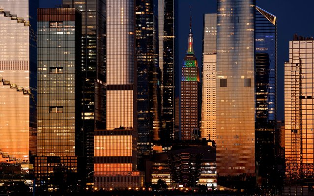 The Empire State Building, standing between the towers of Hudson Yards, illuminates in rainbow colors to mark NYC Pride in New York City as the sun sets on June 29, 2025, as seen from Weehawken, New Jersey. (Photo by Gary Hershorn/Getty Images)