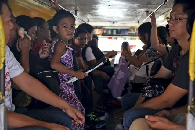 In this September 26, 2017, photo, passengers ride in a jeepney in metropolitan Manila, Philippines. (Photo by Aaron Favila/AP Photo)