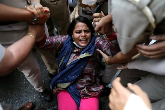 A supporter of India's main opposition Congress party is detained by police during a protest after the death of a rape victim, in front of Uttar Pradesh state bhawan (building) in New Delhi, India, September 30, 2020. (Photo by Anushree Fadnavis/Reuters)