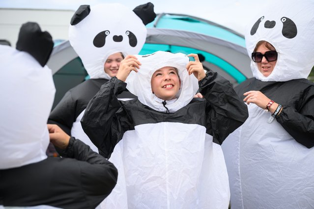 A family don their inflatable panda costumes ahead of the final night of Camp Bestival at Lulworth Castle on August 03, 2025 in Wareham, England. Running from 1-3 August, the annual family-friendly festival sees a range of children's television entertainers share the bill with rock and dance acts across the weekend in the grounds of Lulworth Castle. (Photo by Leon Neal/Getty Images)