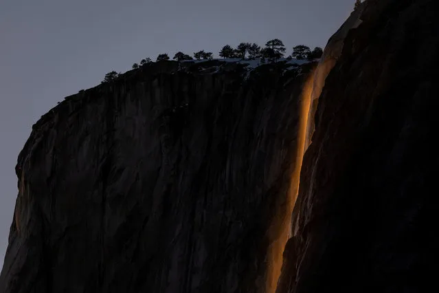 Horsetail Fall at El Capitan is seen during sunset in Yosemite National Park, California, U.S., February 15, 2023. The phenomenon of this vista only occurs for a few days in February each year when several weather and climatic conditions are just righ. (Photo by Carlos Barria/Reuters)