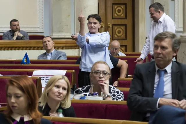 Ukrainian lawmaker Nadiya Savchenko uses the middle finger gesture as she reacts during a session of the parliament in Kiev, Ukraine on June 22, 2017. (Photo by Vladyslav Musiienko/Reuters/Pool)