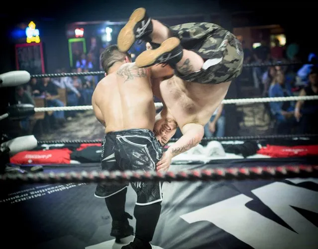 E- Money flips Flyin' Ryan at On The Rocks in Cleveland, Ms., on February 9, 2018. The Micro Wrestling Federation is a full scale, WWE type event sporting an entire cast under five feet tall. Founded in 2000, the MWF is the longest running organization within the Little Person wrestling industry according to its manager. (Photo by Emily Kask/AFP Photo)