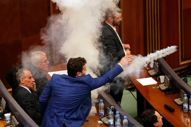 A Kosovo opposition lawmaker throws tear gas for the fourth time before the vote for agreement on border demarcation with Montenegro during a parliamentary session in Pristina, Kosovo, 21 March 2018. Ratification of the border agreement between Kosovo and Montenegro is set by European Union as the main condition before it will grant Kosovo nationals visa-free access to the Schengen area. (Photo by Valdrin Xhemaj/EPA/EFE/Rex Features/Shutterstock)