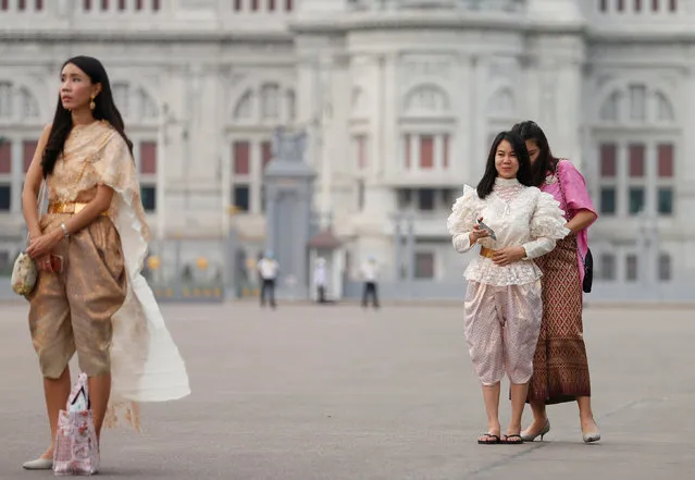People dressed in traditional Thai costumes walk at the Royal Plaza, as interest for historical clothing rises within the country, in Bangkok, Thailand April 6, 2018. (Photo by Soe Zeya Tun/Reuters)