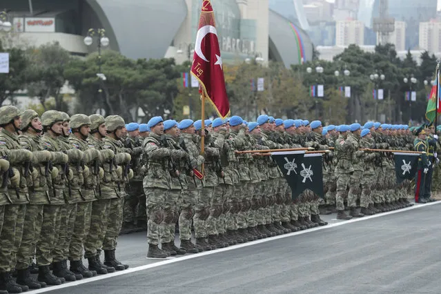 Members of a Turkish forces commando brigade take part in a military parade attended by Turkey's President Recep Tayyip Erdogan and Azerbaijan's President Ilham Aliyev, in Baku, Azerbaijan, Thursday, December 10, 2020. Turkey strongly backed Azerbaijan during the conflict, and the massive parade was held in celebration of the peace deal with Armenia over Nagorno-Karabakh. (Photo by Turkish Presidency via AP Photo, Pool)