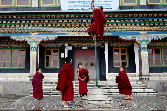 Young Buddhist monks play between prayers at the Tawang monastery in Tawang town in northeast Indian state of Arunachal Pradesh on April 5, 2023. (Photo by Arun Sankar/AFP Photo)