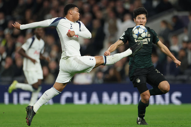 Tottenham's Dane Scarlett, left, duels for the ball with Copenhagen's Junnosuke Suzuki during the Champions League opening phase soccer match between Tottenham and Copenhagen, in London, England, Tuesday, November 4, 2025. (Photo by Ian Walton/AP Photo)